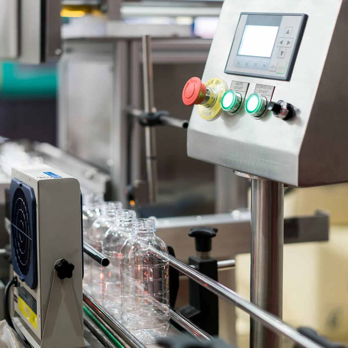 HMI interface controls a conveyor belt for empty plastic bottles in a food and beverage factory.
