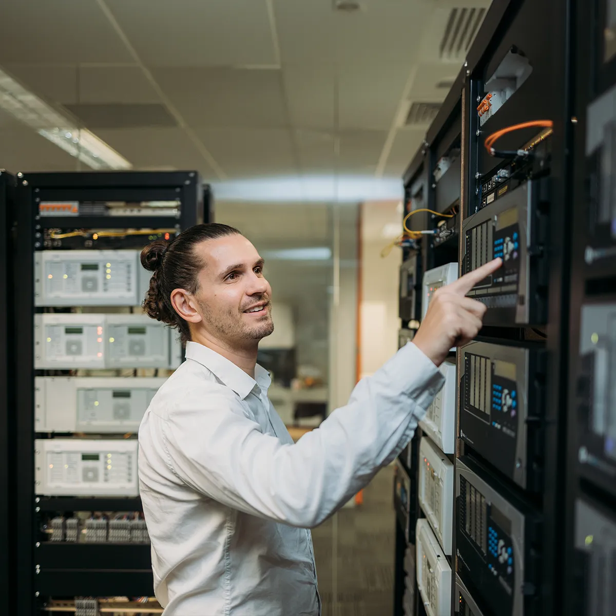 Technician points to a HMI interface used to give operators clear, real-time insights into system performance