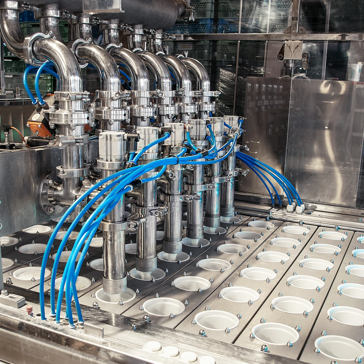 Unit for pouring yogurt into plastic jars at a New Zealand dairy factory